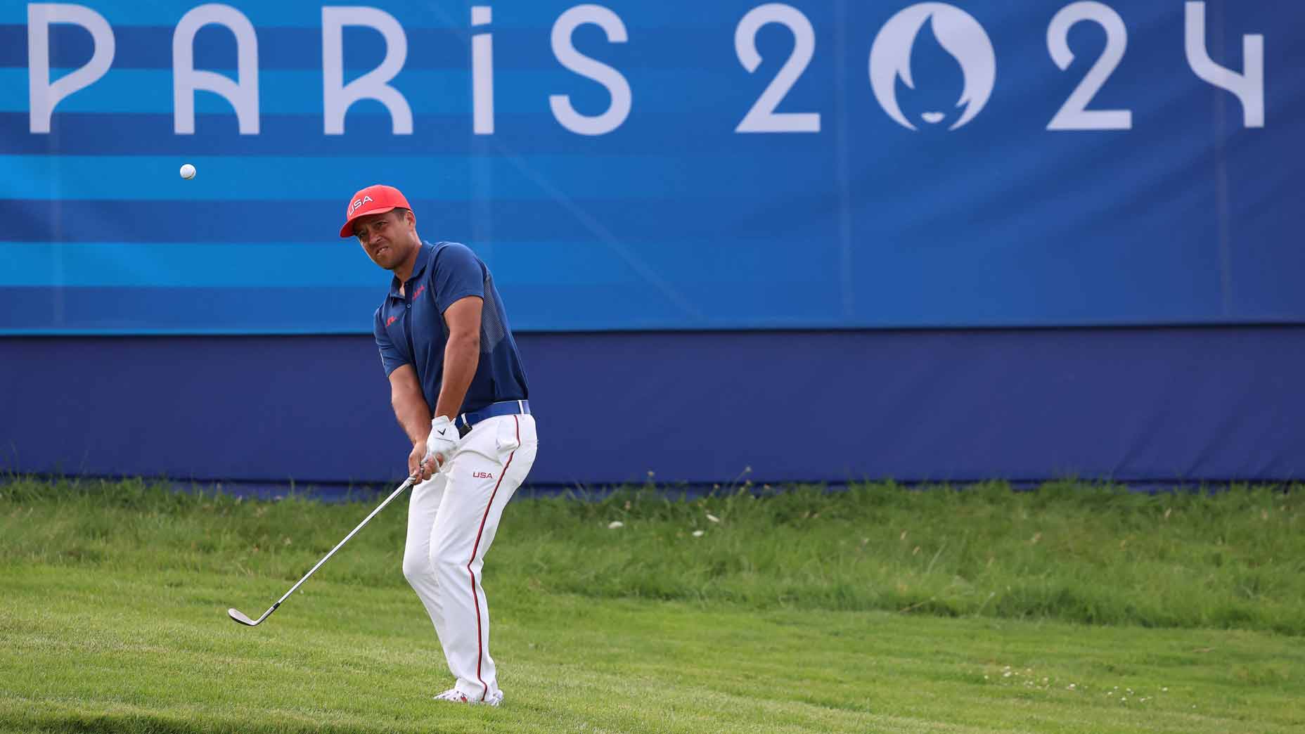 xander schauffele hits a pitch shot during the 2024 olympics